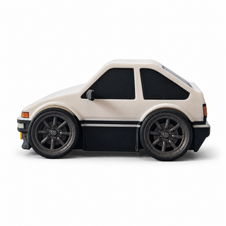 Left side view of a white and black anime-inspired tofu shop drift hatchback tooned 3D printed desk model with wide wheels.