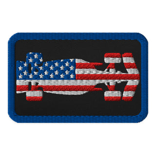 USA flag formula racing car embroidered patch with black background and red, white and blue racing design.